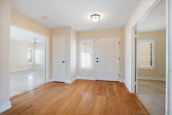 a view of a room with wooden floor and a bathroom