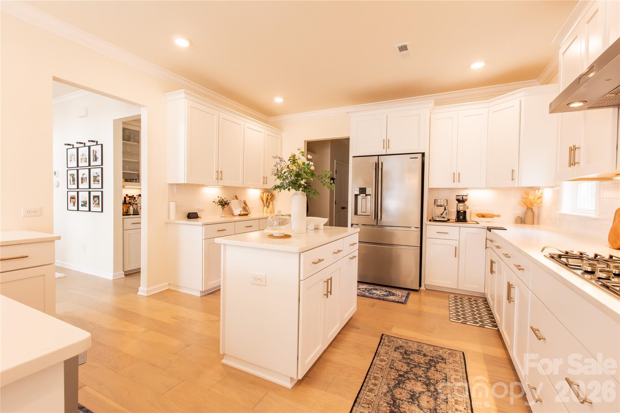 2936 Haley Circle Davidson, NC 28036 - Photo 15 of 45 a kitchen with white cabinets and stainless steel appliances