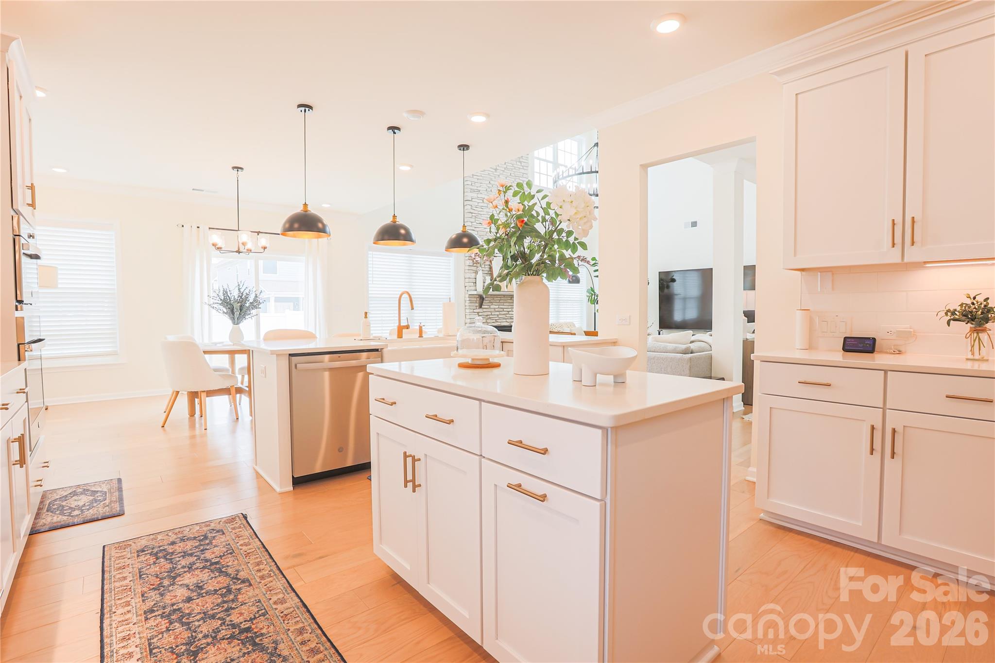 2936 Haley Circle Davidson, NC 28036 - Photo 16 of 45 a kitchen with kitchen island granite countertop a sink and white cabinets