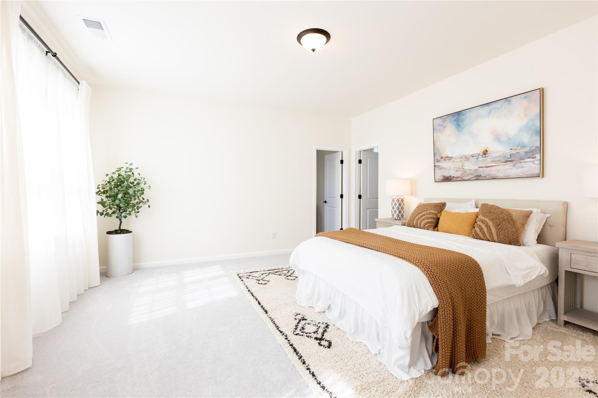2936 Haley Circle Davidson, NC 28036 - Photo 25 of 45 a spacious bedroom with a bed and a potted plant