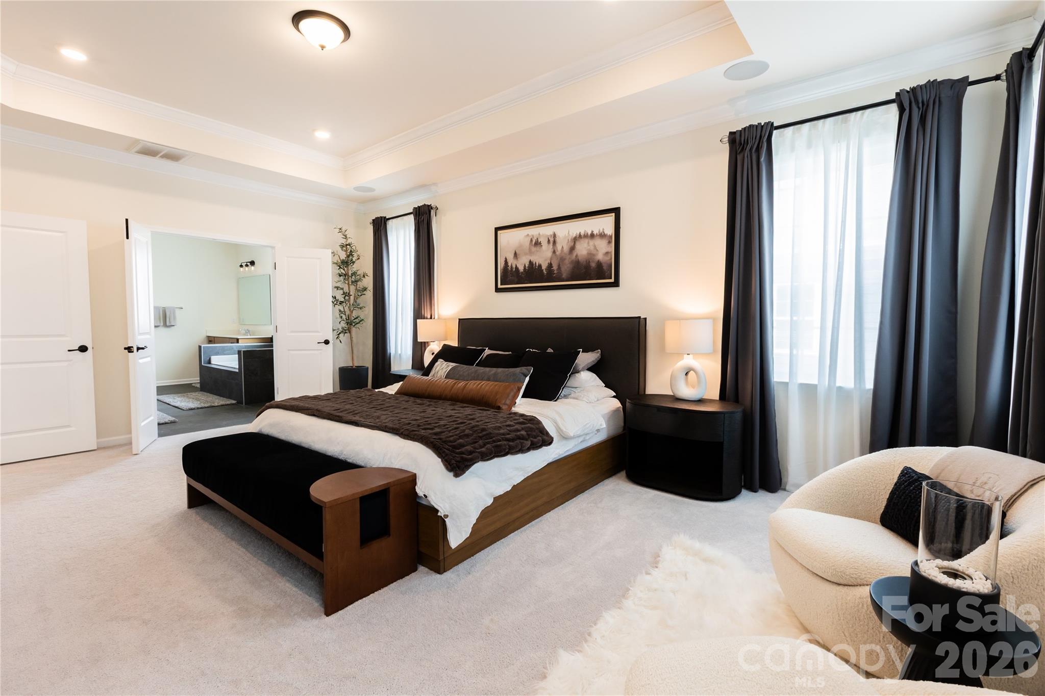 2936 Haley Circle Davidson, NC 28036 - Photo 27 of 45 a spacious bedroom with a bed a couch and a window