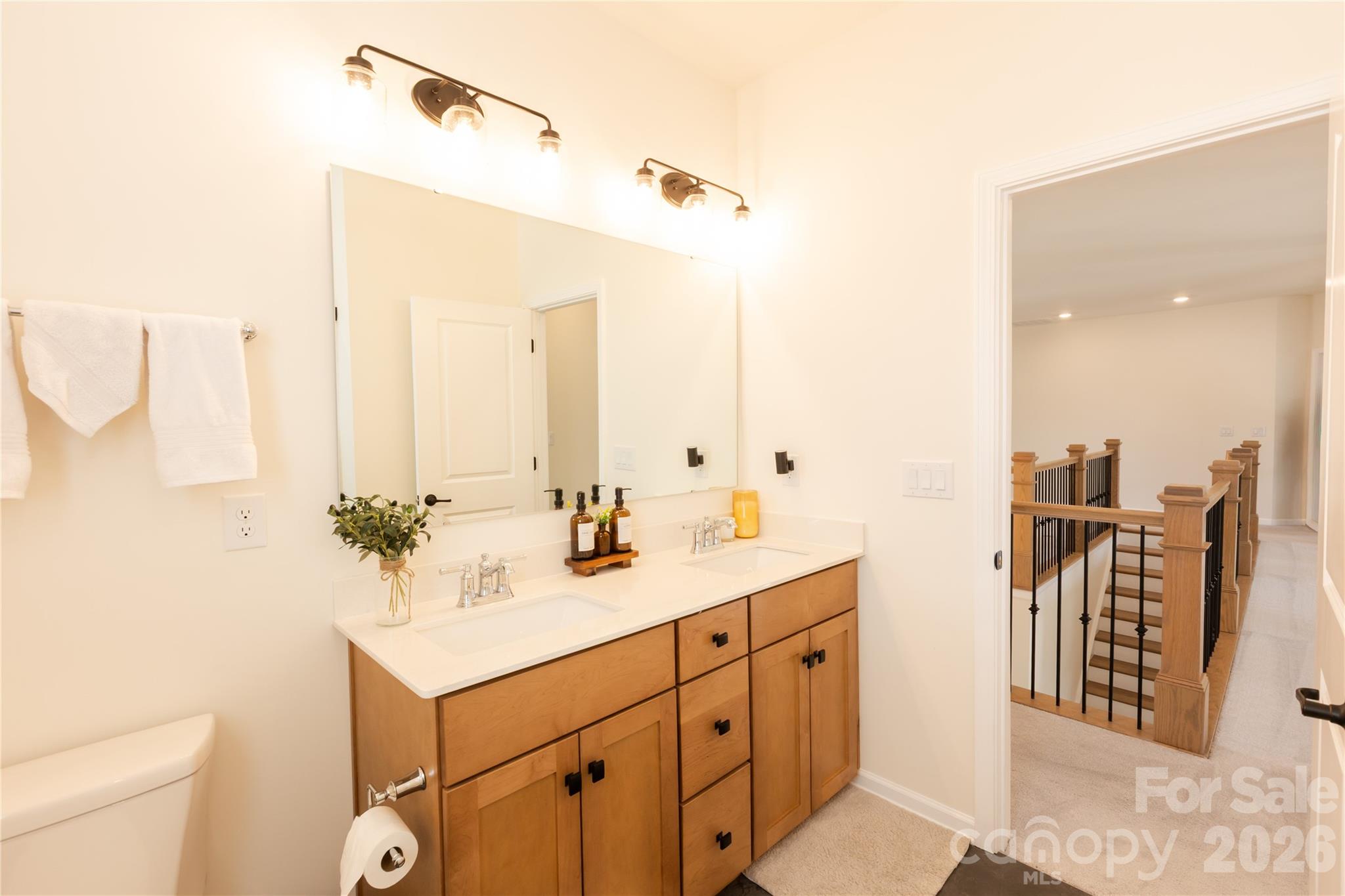 2936 Haley Circle Davidson, NC 28036 - Photo 37 of 45 a bathroom with a sink and mirror with toilet