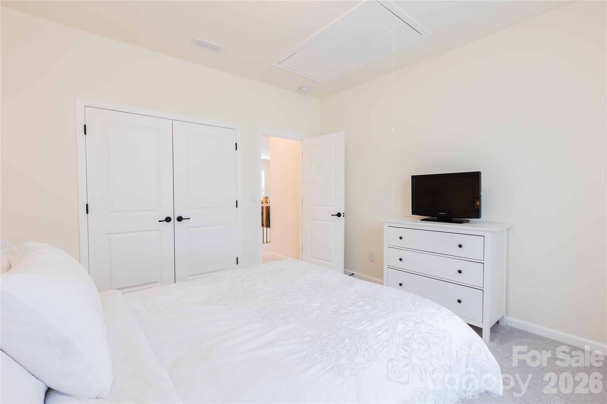 2936 Haley Circle Davidson, NC 28036 - Photo 40 of 45 a bedroom with a bed and a flat screen tv