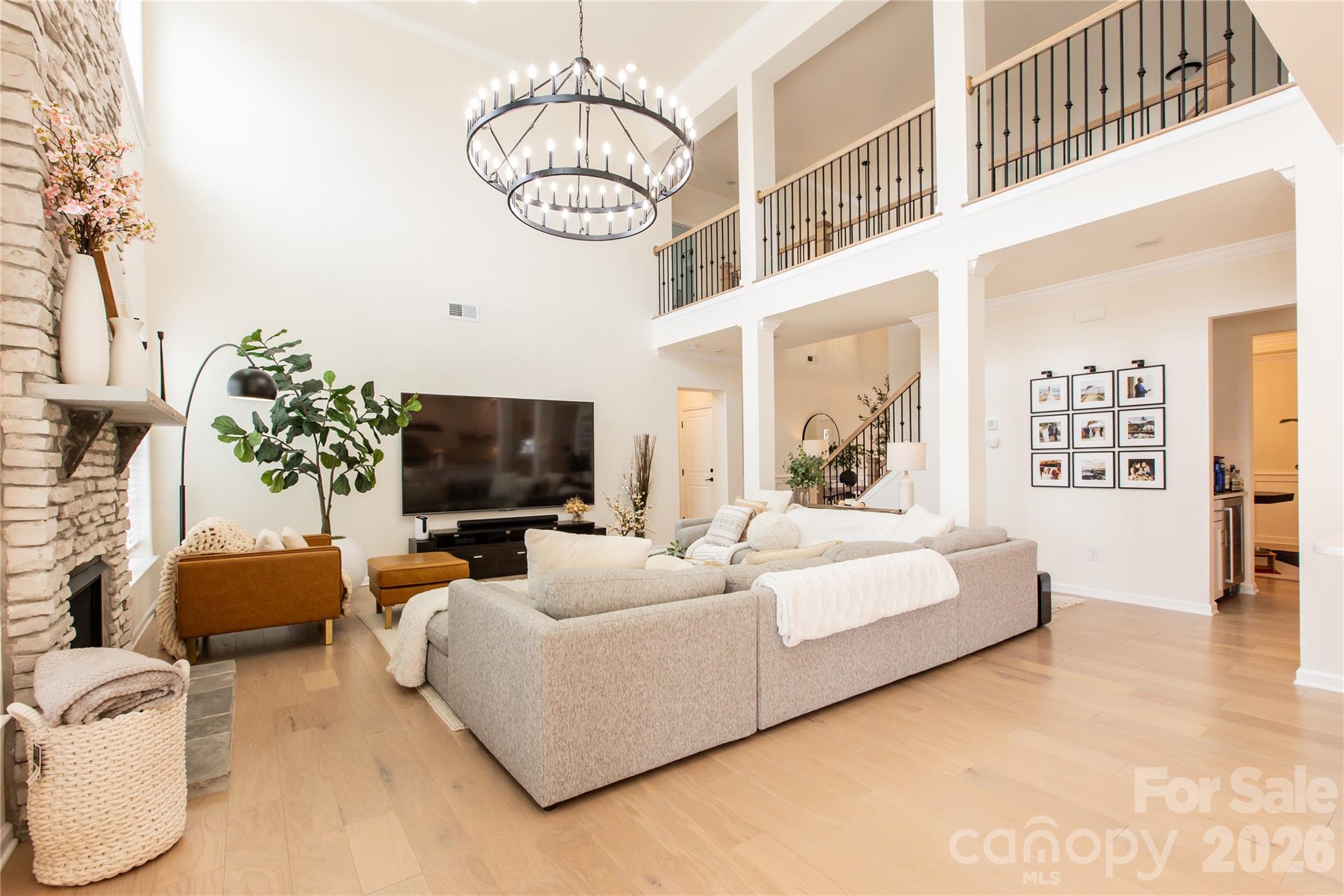 2936 Haley Circle Davidson, NC 28036 - Photo 10 of 45 a living room with furniture a chandelier and a flat screen tv