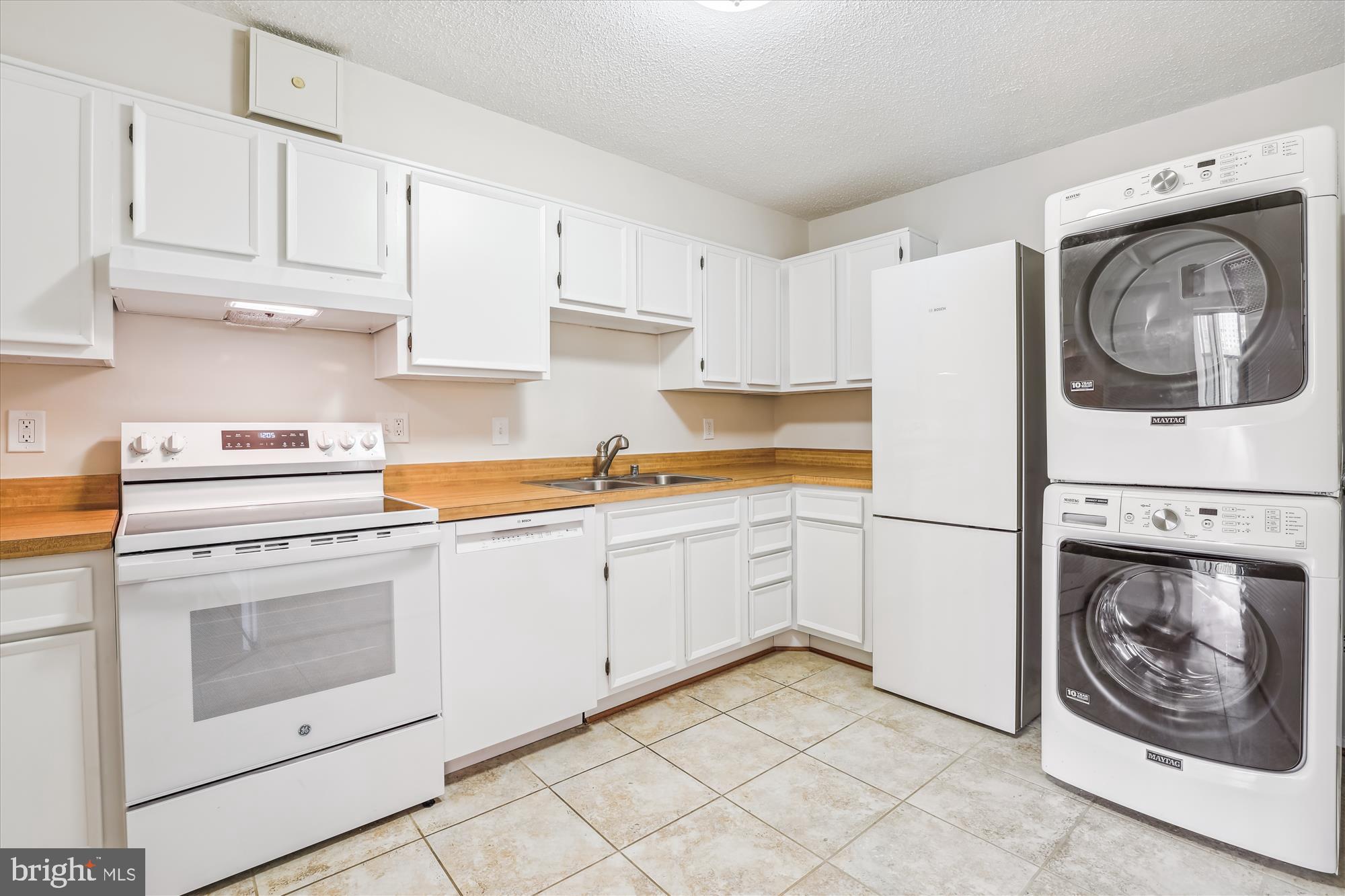 5904 Mt Eagle Drive, Unit 1109 Alexandria, VA 22303 - Photo 11 of 43 a kitchen with cabinets and washer dryer