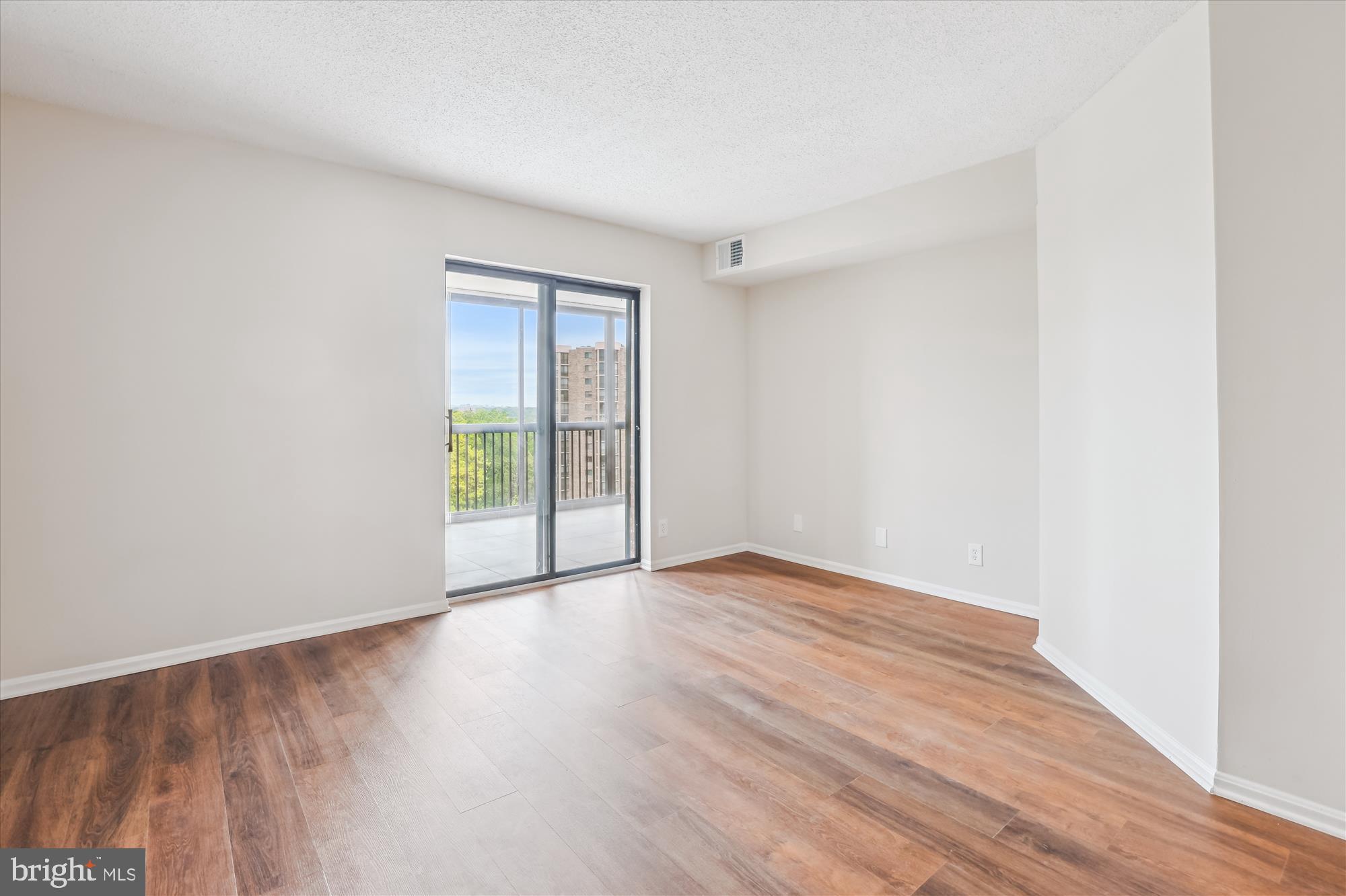 5904 Mt Eagle Drive, Unit 1109 Alexandria, VA 22303 - Photo 13 of 43 a view of an empty room with wooden floor and a window