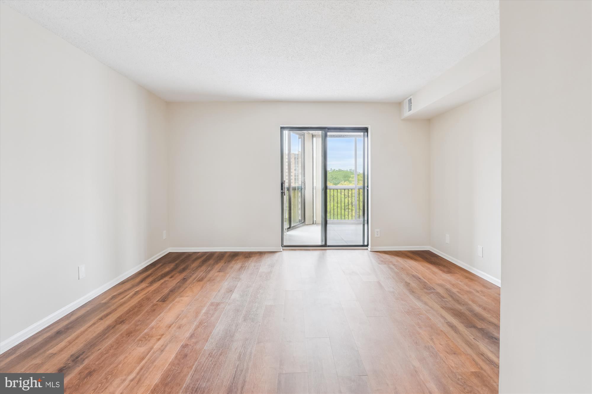 5904 Mt Eagle Drive, Unit 1109 Alexandria, VA 22303 - Photo 16 of 43 an empty room with wooden floor and windows
