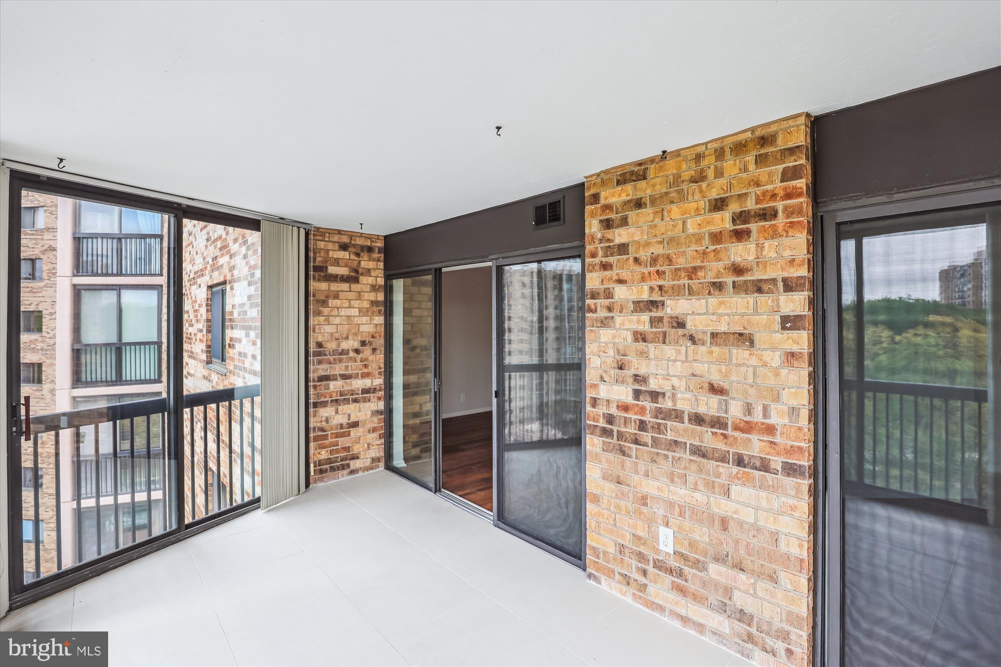 5904 Mt Eagle Drive, Unit 1109 Alexandria, VA 22303 - Photo 22 of 43 a view of empty room with floor to ceiling window and wooden floor
