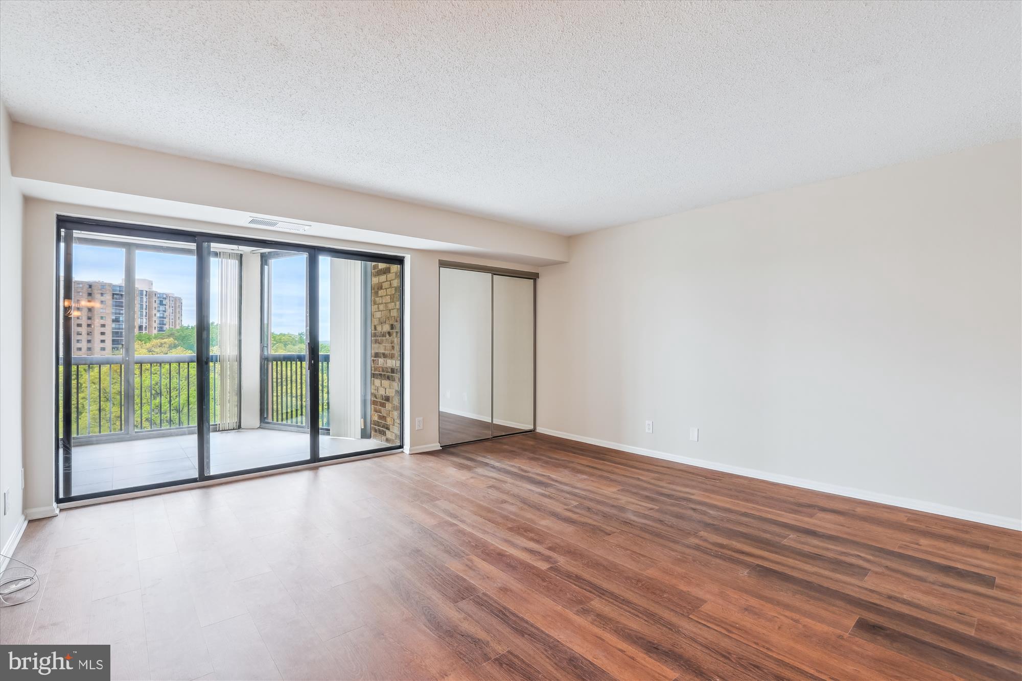 5904 Mt Eagle Drive, Unit 1109 Alexandria, VA 22303 - Photo 6 of 43 a view of an empty room with wooden floor
