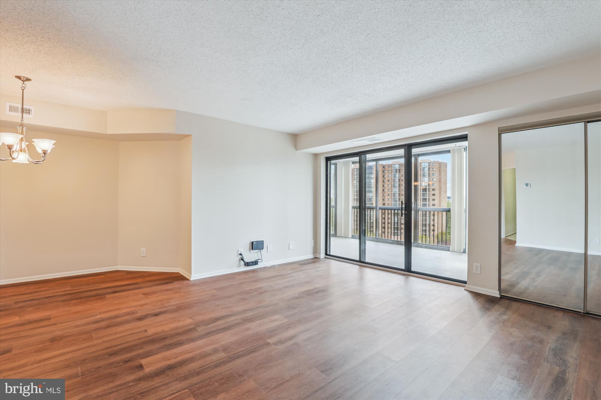 5904 Mt Eagle Drive, Unit 1109 Alexandria, VA 22303 - Photo 7 of 43 a view of an empty room with wooden floor and a window