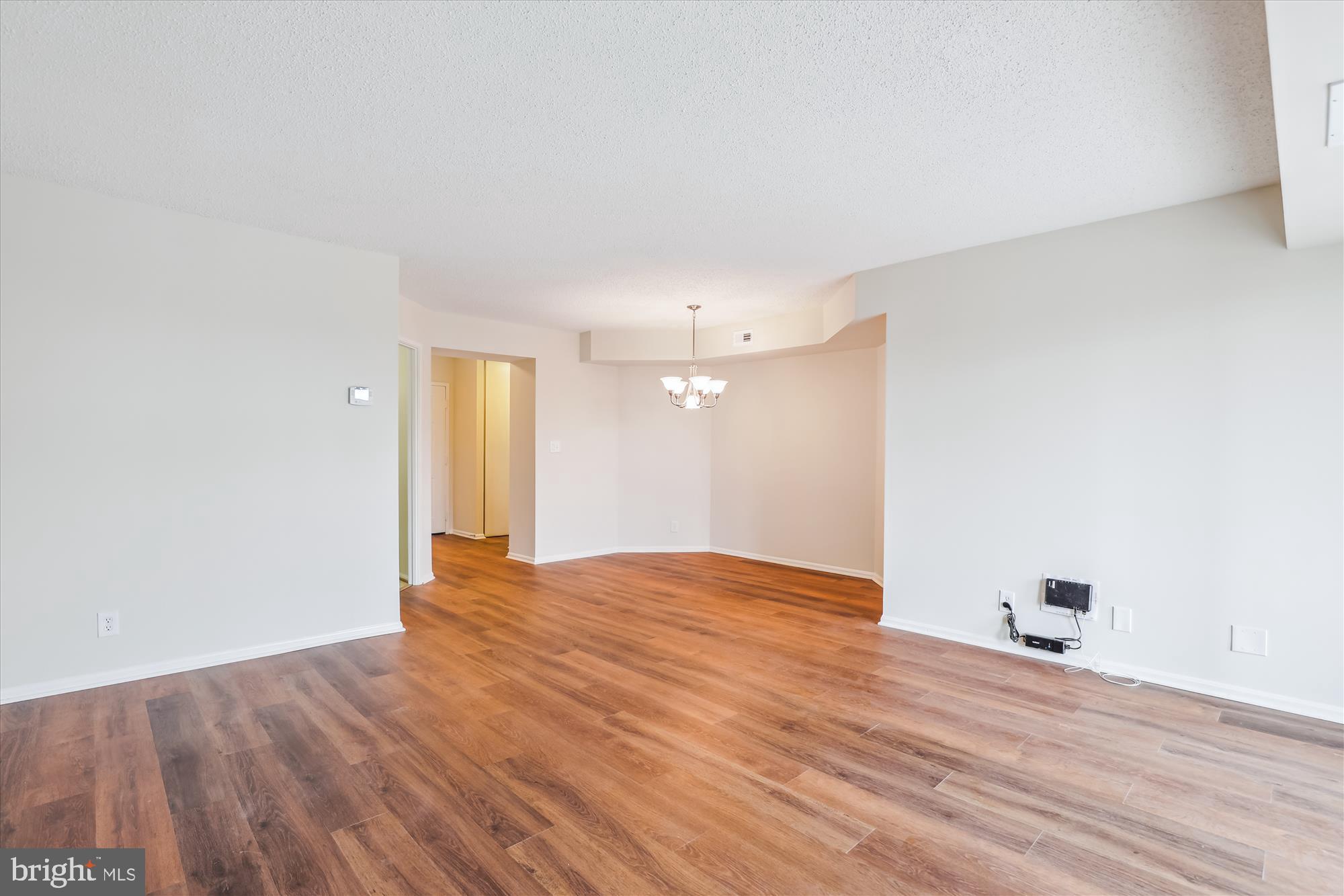 5904 Mt Eagle Drive, Unit 1109 Alexandria, VA 22303 - Photo 8 of 43 a view of an empty room with wooden floor and a window