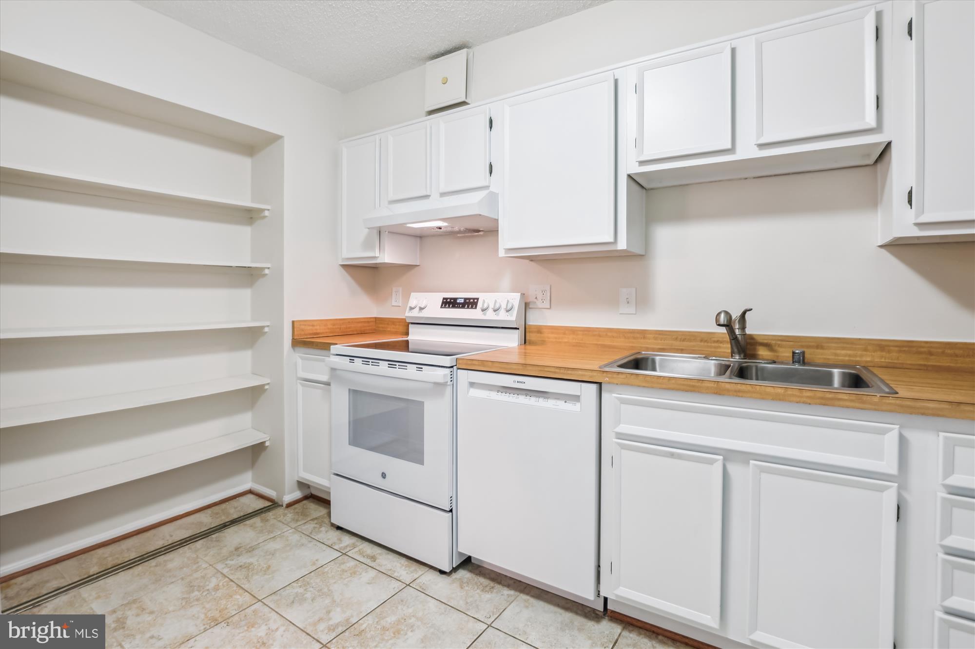 5904 Mt Eagle Drive, Unit 1109 Alexandria, VA 22303 - Photo 10 of 43 a kitchen with white cabinets and white appliances