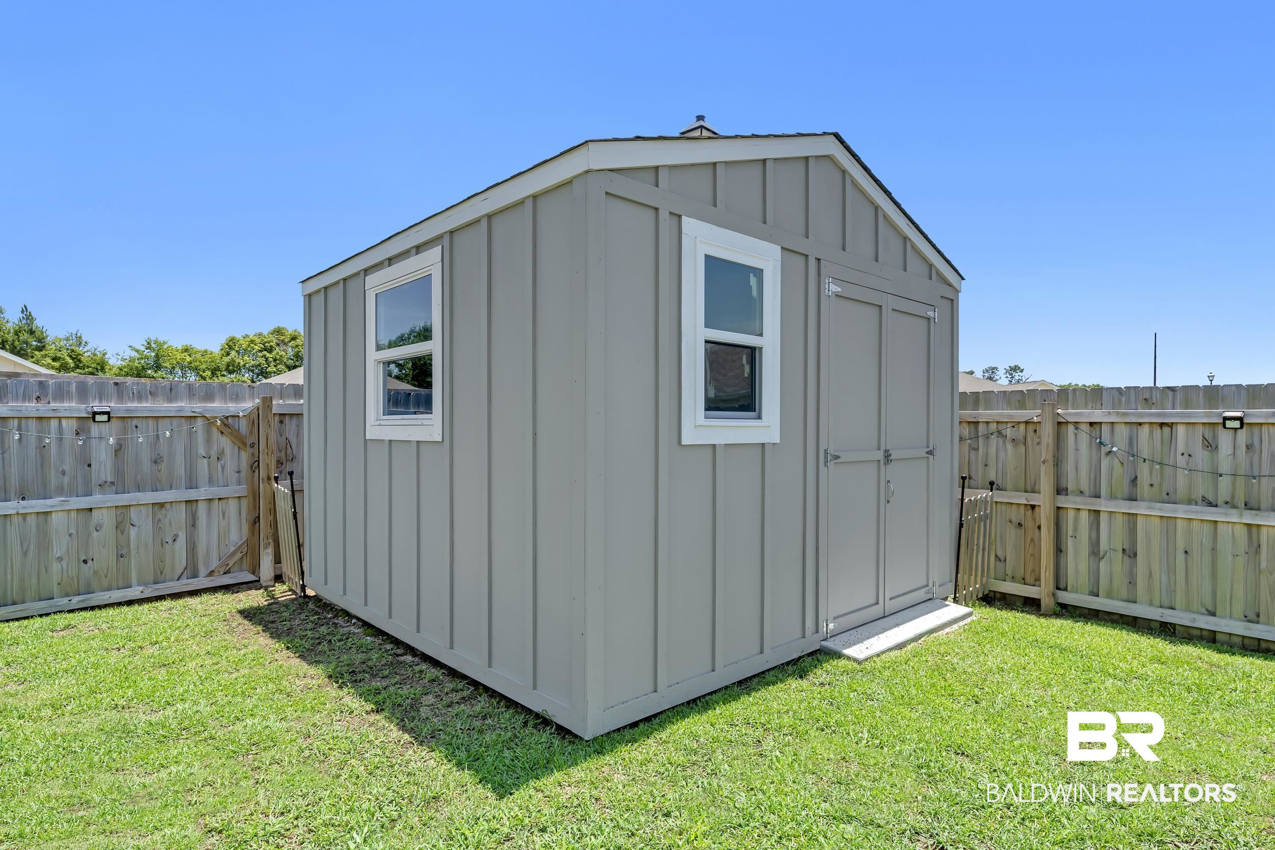 24271 Ringneck Loop Elberta, AL 36530 - Photo 44 of 44 Gable-roof storage shed with board-and-batten siding and dual windows