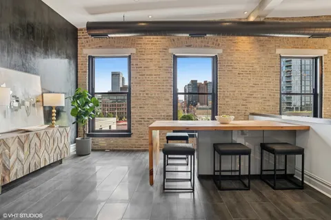 a kitchen with a table chairs and a wooden floor