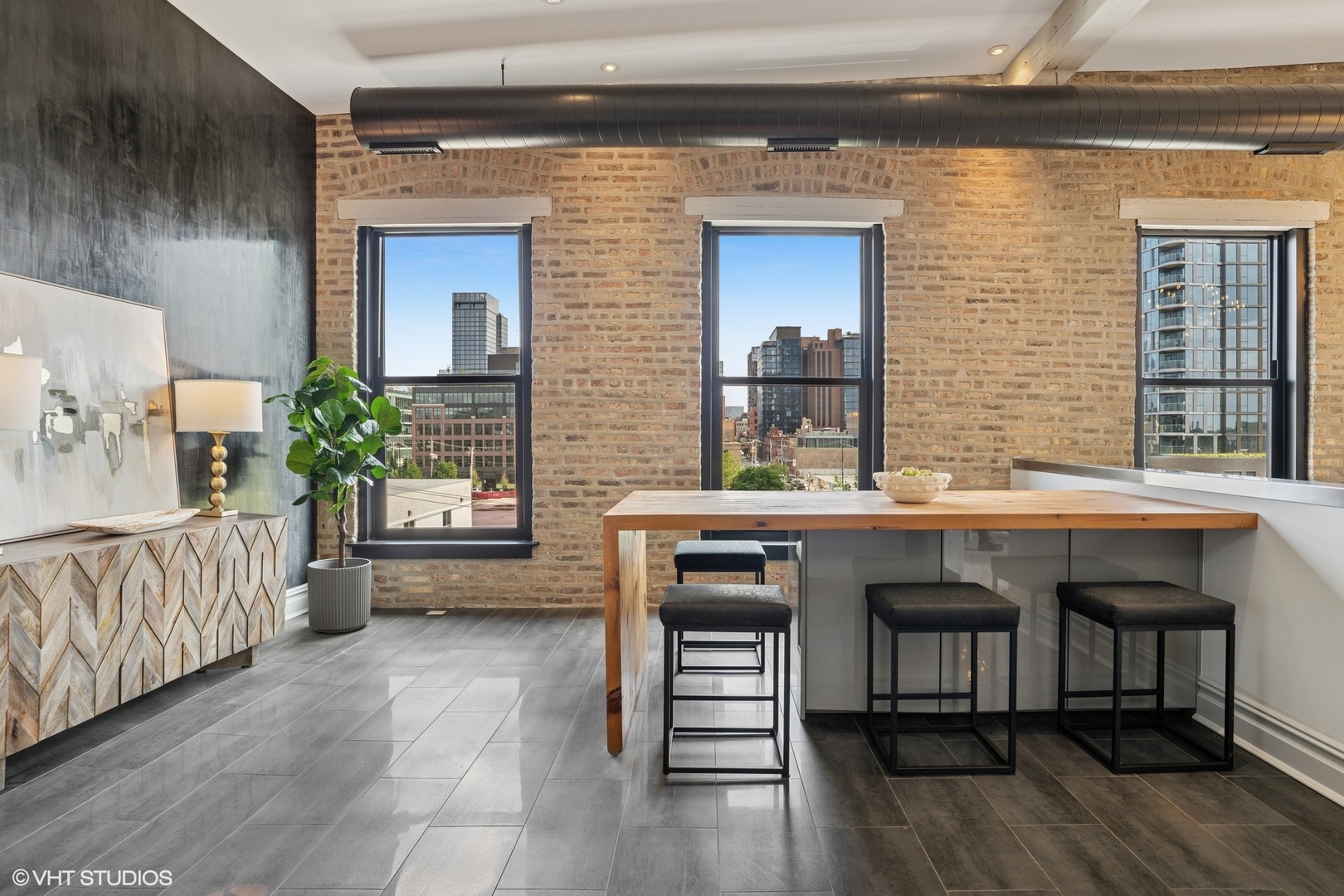 401 North Aberdeen Street, Unit 4S Chicago, IL 60642 - Photo 11 of 33 a kitchen with a table chairs and a wooden floor