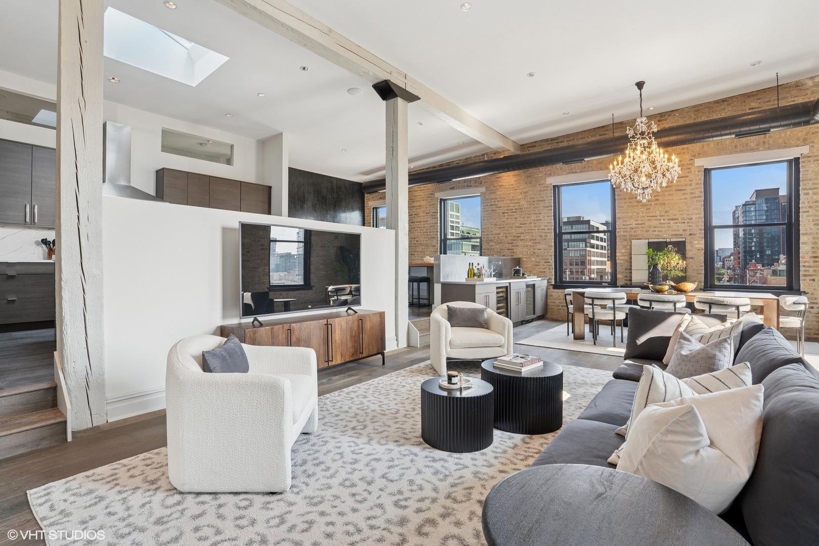 401 North Aberdeen Street, Unit 4S Chicago, IL 60642 - Photo 13 of 33 a living room with furniture a chandelier and a flat screen tv