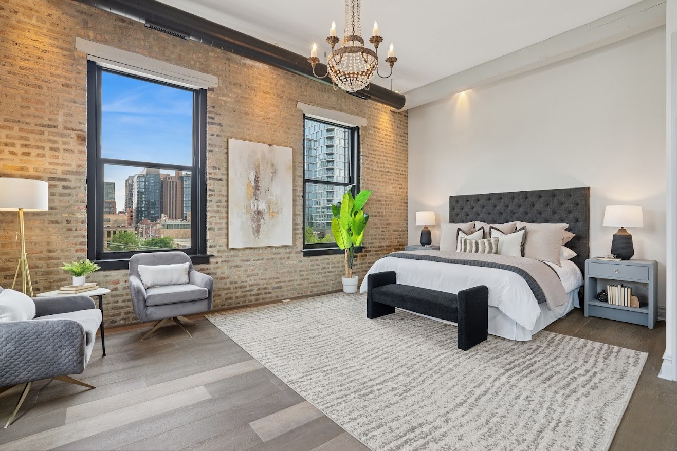 401 North Aberdeen Street, Unit 4S Chicago, IL 60642 - Photo 16 of 33 a spacious bedroom with a bed a couch and a chandelier