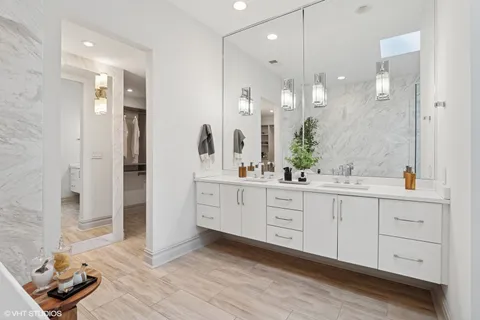 a spacious bathroom with a granite countertop sink mirror and shower
