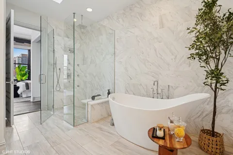 a bathroom with a bathtub and a shower