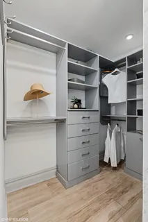 a view of walk in closet with clothes and shoes