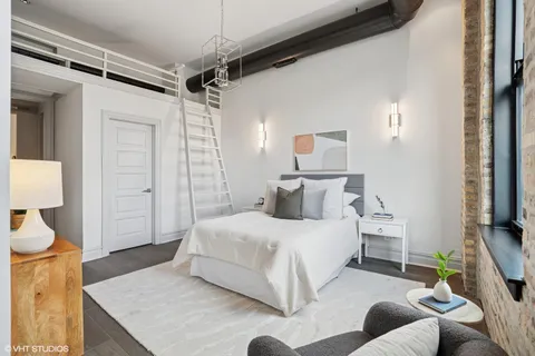 a bedroom with a bed and a lamp on table