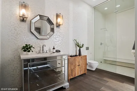 a spacious bathroom with a toilet sink and mirror