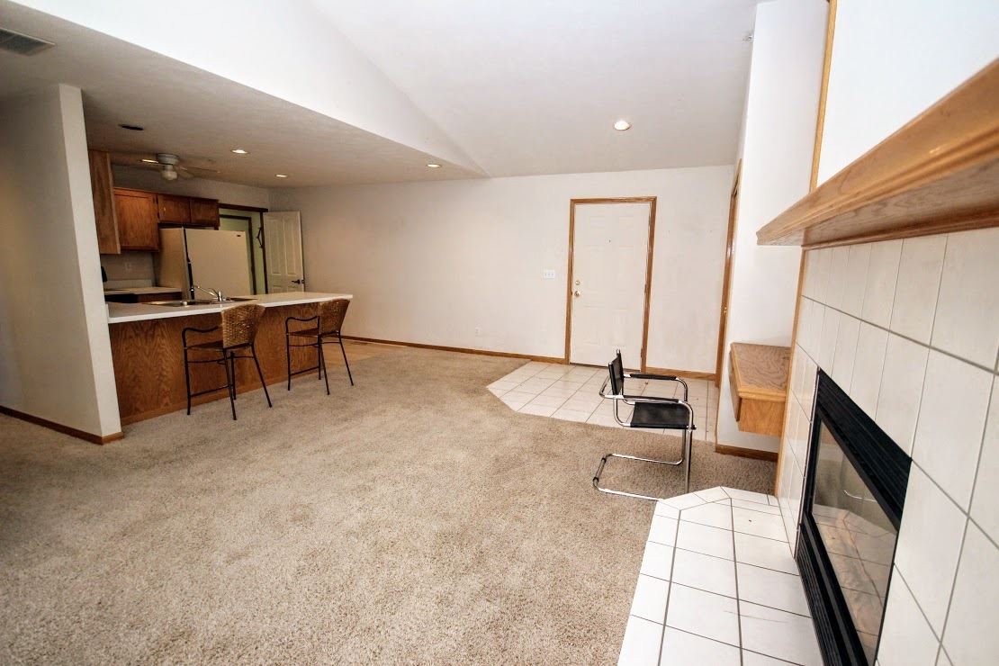 7260 North Alpine Road, Unit 3 Loves Park, IL 61111 - Photo 3 of 14 a living room with furniture a fireplace and a flat screen tv
