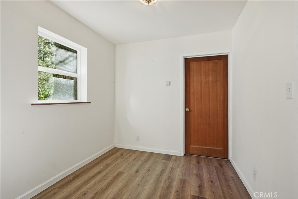 10313 Brookside Drive Middletown, CA 95461 - Photo 9 of 20 an empty room with wooden floor and a window