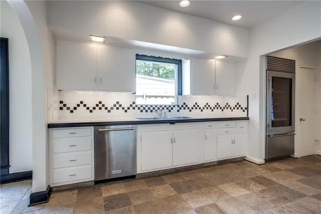 a large kitchen with a stove and a sink