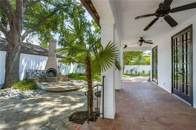 a view of a house with a tree in front of it