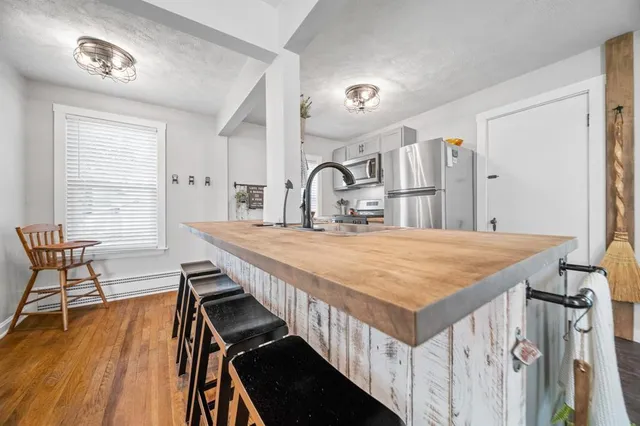 a dining table with chair and wooden floor