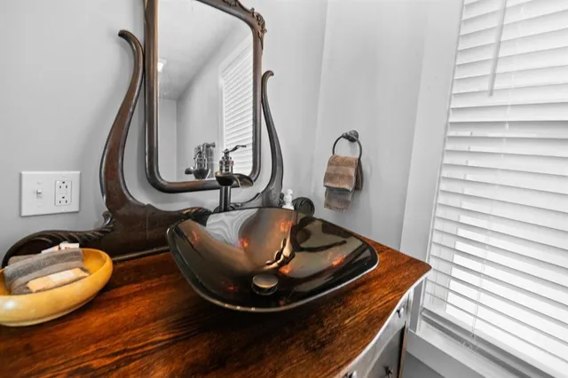a picture of a bathroom with a sink and a mirror