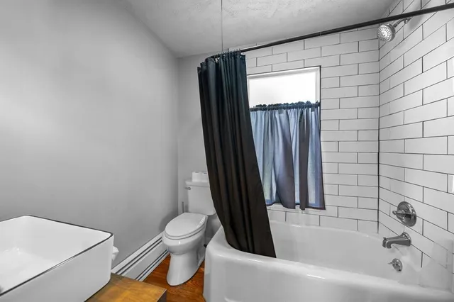 a bathroom with a toilet a sink and bathtub