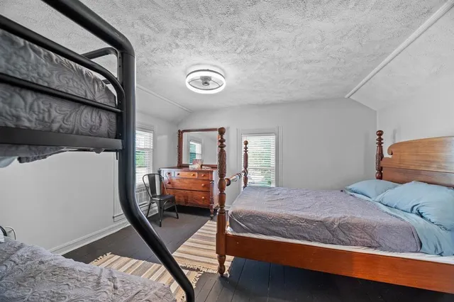 a bedroom with furniture and a wooden floor