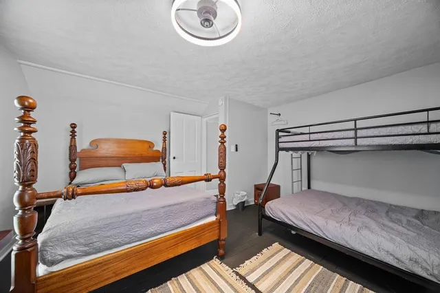 a bedroom with furniture and a large window