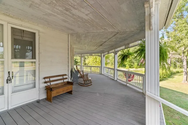 an empty room with sliding glass door and wooden floor