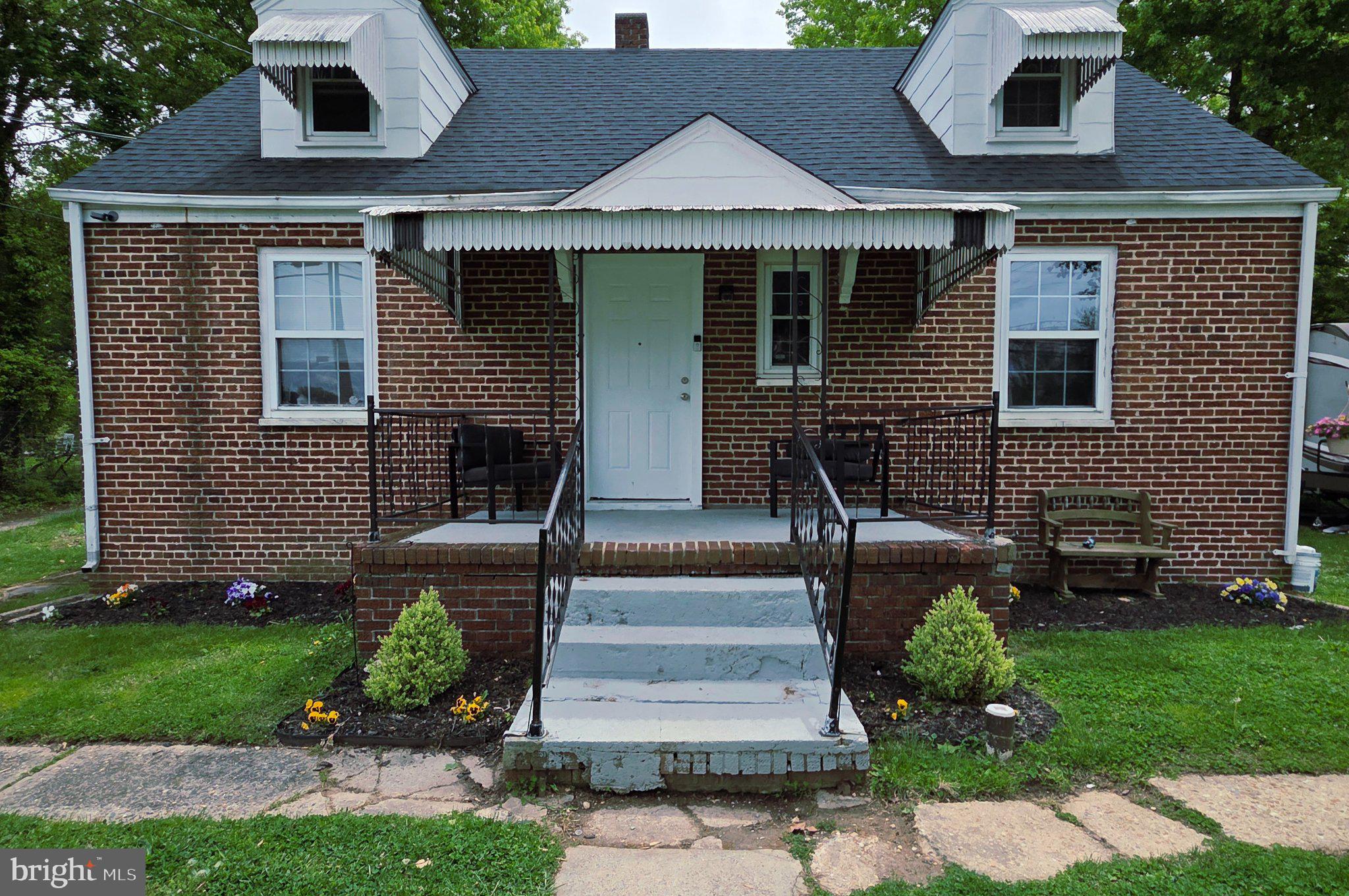 Charming brick home with inviting porch.