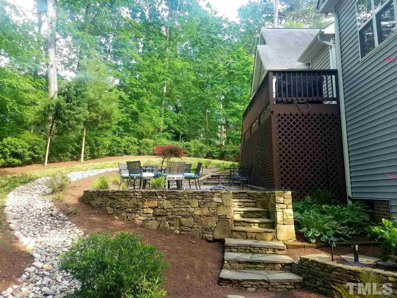 6 Providence Ridge Road Durham, NC 27713 - Photo 22 of 25 a view of a patio with table and chairs potted plants and large tree