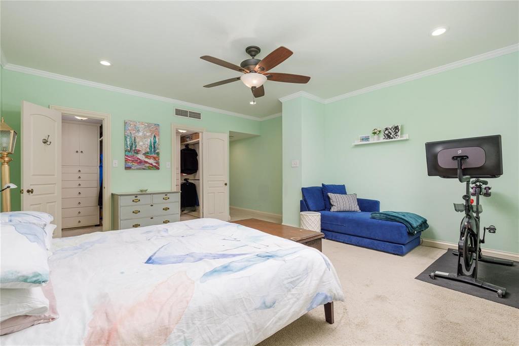 6126 Averill Way, Unit 103W Dallas, TX 75225 - Photo 19 of 34 a bedroom with a bed and a chandelier