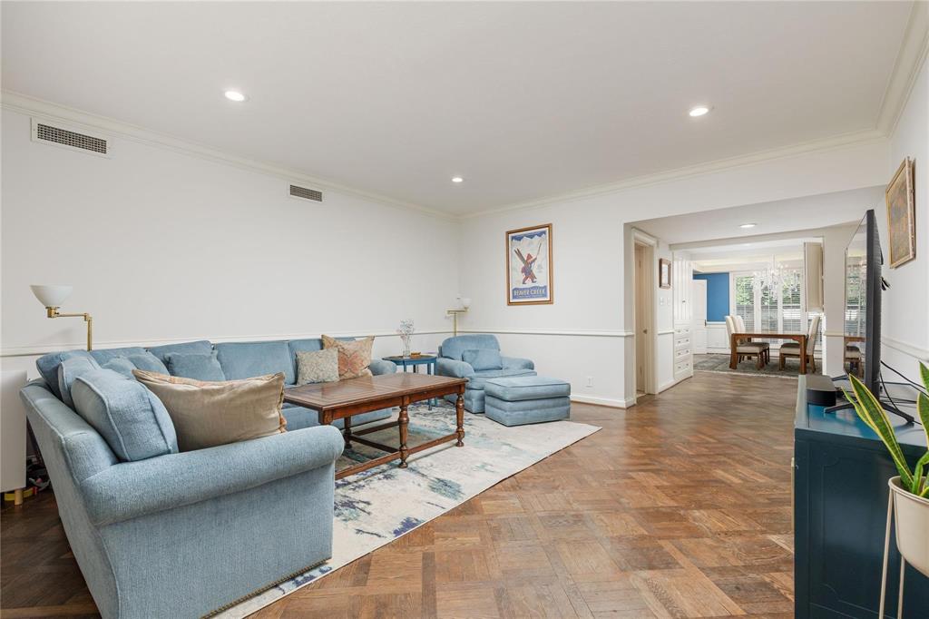 6126 Averill Way, Unit 103W Dallas, TX 75225 - Photo 2 of 34 a living room with furniture and wooden floor