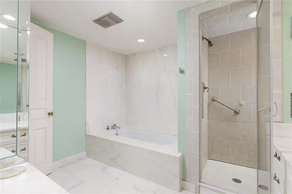 a bathroom with a bathtub and a shower