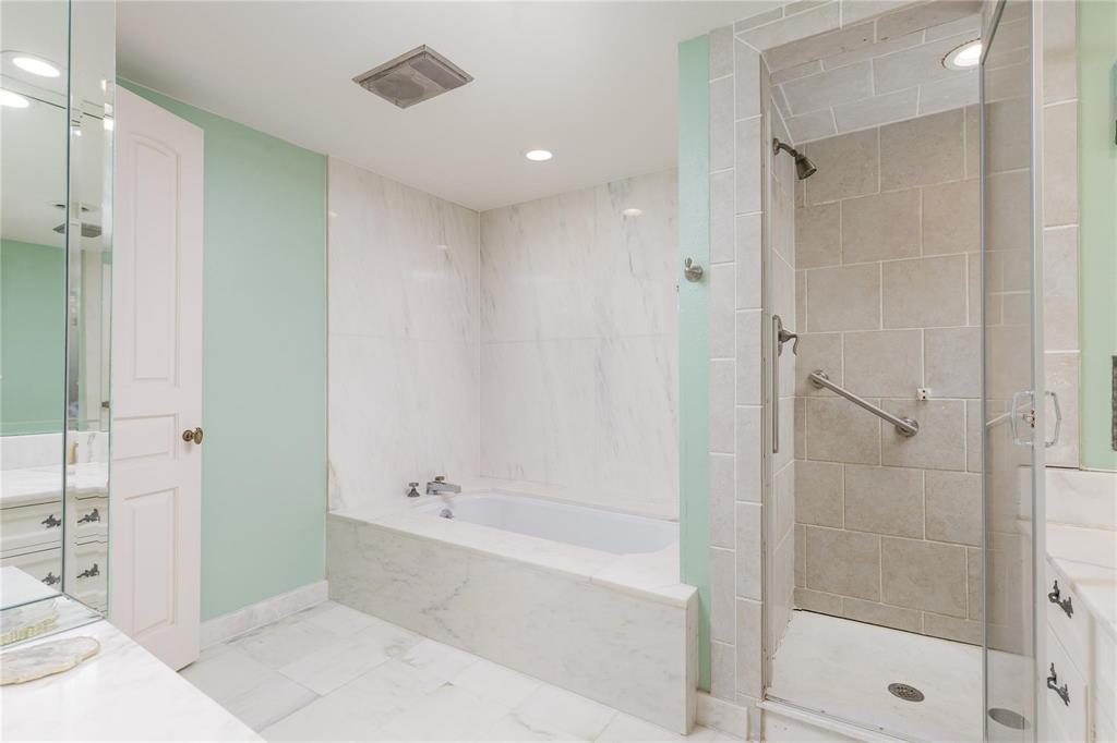 6126 Averill Way, Unit 103W Dallas, TX 75225 - Photo 22 of 34 a bathroom with a bathtub and a shower