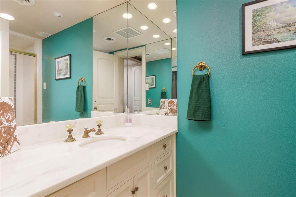 6126 Averill Way, Unit 103W Dallas, TX 75225 - Photo 25 of 34 a bathroom with a sink double vanity and a mirror