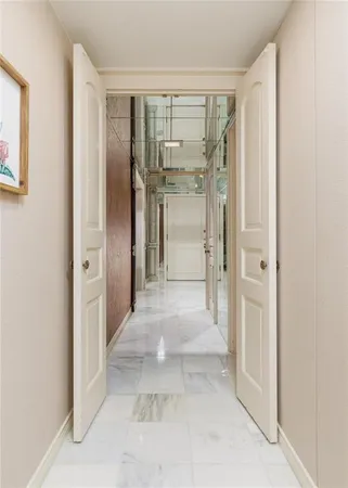 a view of a hallway with wooden shelves