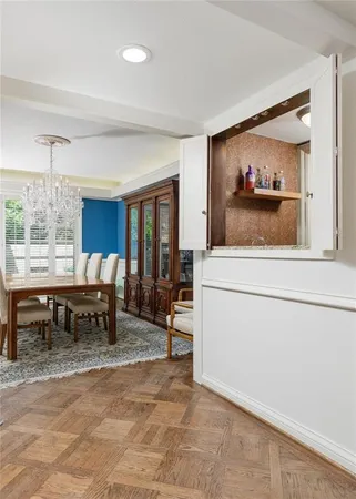 a living room with furniture and a dining table
