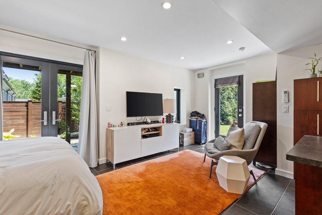 62 Grampian Way, Unit STUDIO Boston, MA 02125 - Photo 17 of 25 a bedroom with a bed and a flat screen tv