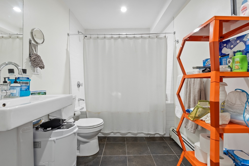 62 Grampian Way, Unit STUDIO Boston, MA 02125 - Photo 19 of 25 a bathroom with a sink a toilet and shower