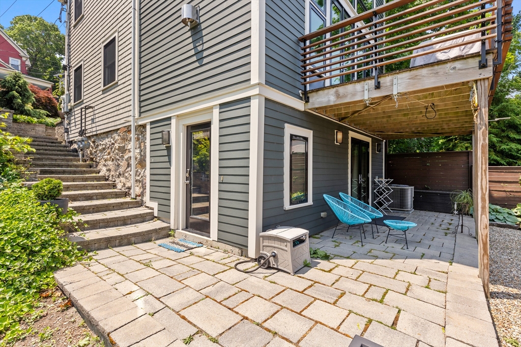 62 Grampian Way, Unit STUDIO Boston, MA 02125 - Photo 23 of 25 a view of a patio with table and chairs and wooden fence