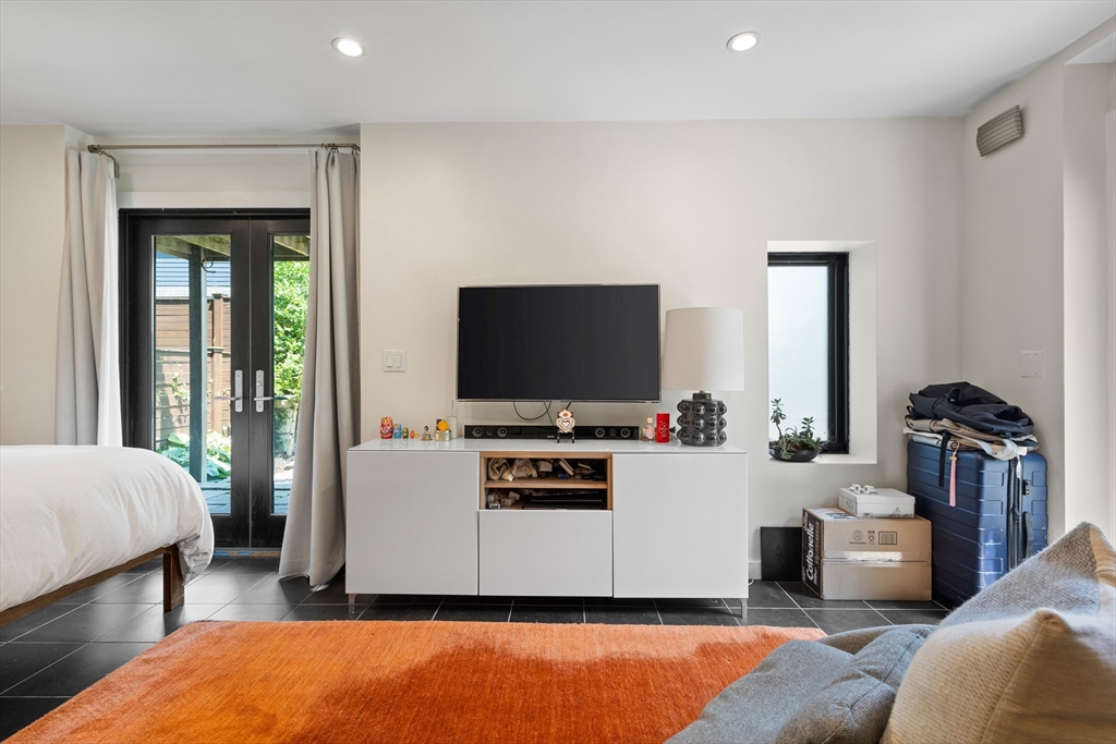 62 Grampian Way, Unit STUDIO Boston, MA 02125 - Photo 4 of 25 a living room with furniture and a flat screen tv