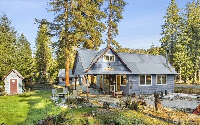 a front view of a house with a yard table and chairs